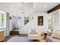 Bright and airy living room featuring a soaring ceiling, wood floors, and modern decor at 4850 S Kittredge St, Aurora, CO 80015
