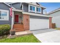 Inviting entrance with a bright red door, American flag, and a cozy porch, creating a welcoming feel at 748 Poppywood Pl, Highlands Ranch, CO 80126