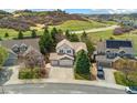Residential home in a neighborhood with mountain views, mature landscaping, and a cul-de-sac street at 627 Millbrook Cir, Castle Rock, CO 80109