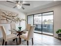 Dining area with a glass table, comfortable chairs, and sliding doors to the balcony at 14150 E Temple Dr # V06, Aurora, CO 80015