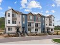 View of stylish townhouses with multi-tone exteriors, small balconies, and landscaped frontage at 14492 Pansy Loop, Morrison, CO 80465