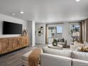 A bright living room with modern decor, stylish furnishing, and sleek wooden floors at 14492 Pansy Loop, Morrison, CO 80465