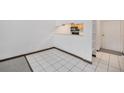 Open living area featuring tile flooring next to an open kitchen and large doorway at 707 W 96Th Ave # 5, Thornton, CO 80260