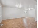 Bright and spacious living room featuring hardwood floors and modern lighting at 3110 W 66Th Ave, Denver, CO 80221