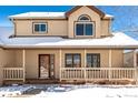 Two-story house with a covered porch, snow on the ground, and visible architectural details at 1506 Maple Dr, Berthoud, CO 80513