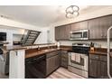 Modern kitchen featuring stainless steel appliances and wooden cabinets at 13744 E Lehigh Ave # B, Aurora, CO 80014