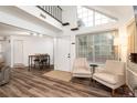 Bright living room featuring a high ceiling with large windows and modern flooring at 13744 E Lehigh Ave # B, Aurora, CO 80014