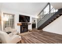 Inviting living area with a fireplace, TV, and staircase leading to the upper level at 13744 E Lehigh Ave # B, Aurora, CO 80014
