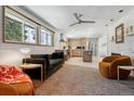 Open-concept living room features hardwood floors, modern furniture, and ample natural light from large windows at 8540 W 59Th Ave, Arvada, CO 80004