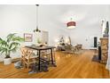 Open-concept dining area featuring hardwood floors, a modern table, and stylish lighting at 3147 W 39Th Ave, Denver, CO 80211