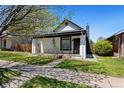 Charming single-story home with a quaint front porch, landscaped garden, and inviting curb appeal at 3147 W 39Th Ave, Denver, CO 80211