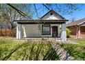 Charming single-story home with a quaint front porch, landscaped garden, and inviting curb appeal at 3147 W 39Th Ave, Denver, CO 80211