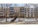 Exterior of building with stair access, mature trees, and architectural facade at 3470 S Poplar St # 401, Denver, CO 80224