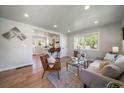 Sun-drenched living room shows open concept to newly remodeled kitchen and updated finishes at 3216 Elizabeth, Denver, CO 80205