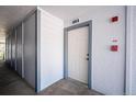 Hallway view of apartment unit number 302 with white door and blue trim at 13095 W Cedar Dr # 302, Lakewood, CO 80228