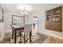 Elegant dining room with hardwood floors, a chandelier, and a built-in cabinet at 12176 W Ohio Pl, Lakewood, CO 80228