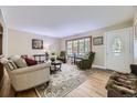 Bright living room featuring hardwood floors, a large window, and a cozy seating area at 12176 W Ohio Pl, Lakewood, CO 80228