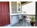 Cozy front porch area with a charming table and chairs, perfect for relaxing at 14763 Pepper Pike Pl, Parker, CO 80134