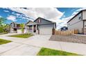 Beautiful home featuring a well-maintained lawn, a two-car garage, and a welcoming front porch in a pleasant neighborhood at 4642 Longs Peak St, Brighton, CO 80601