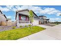 Attractive home boasting a manicured lawn, a two-car garage, and a cozy front porch with delightful curb appeal at 4642 Longs Peak St, Brighton, CO 80601