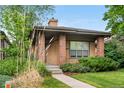 Charming single-story home with brick accents, manicured landscaping, and a welcoming front porch at 1076 Rosemary St, Denver, CO 80230
