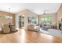 Bright living room and dining area with hardwood floors, fireplace, and sliding glass door to the patio at 1076 Rosemary St, Denver, CO 80230