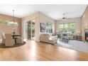 Bright living room featuring hardwood floors, a fireplace, large windows and access to an outdoor patio at 1076 Rosemary St, Denver, CO 80230
