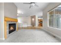 Bright, open-concept living area features a cozy fireplace, large window, and seamless flow into the kitchen at 1076 Rosemary St, Denver, CO 80230