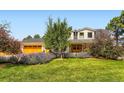 Charming two-story home with a well-manicured lawn and beautiful landscaping at 6709 Walker Ct, Niwot, CO 80503