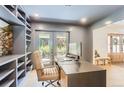 Bright office with a modern desk, built-in shelves, and access to a private outdoor space at 6709 Walker Ct, Niwot, CO 80503