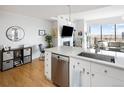 Bright kitchen featuring stainless steel appliances, quartz countertops, and an island with bar seating at 2990 E 17Th Ave # 1004, Denver, CO 80206