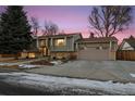 House exterior showcasing a well-maintained yard and attractive facade at dusk at 11177 W 68Th Pl, Arvada, CO 80004