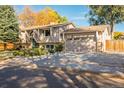 Ranch style home with mature trees and a spacious driveway at 11177 W 68Th Pl, Arvada, CO 80004