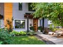 Inviting two-story home with a wood door, xeriscape landscaping, and elegant front entry at 3168 W 29Th Ave, Denver, CO 80211