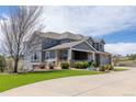 Well-maintained two-story home with manicured lawn and a welcoming covered porch at 2339 Elkhorn St, Parker, CO 80138