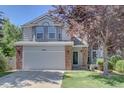 Charming two-story home featuring a brick-accented facade and a well-manicured front yard at 13382 Franklin St, Thornton, CO 80241