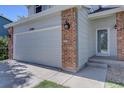 Spacious two-car garage featuring brick accents and convenient access to the front entrance at 13382 Franklin St, Thornton, CO 80241