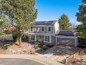 Attractive two-story home featuring solar panels and a well-maintained yard under a sunny sky at 1024 S Mobile St, Aurora, CO 80017