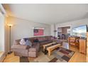 Spacious living room with a comfortable sectional sofa and a cozy fireplace in view at 1024 S Mobile St, Aurora, CO 80017