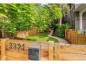 Home exterior with address on a wood fence, garden, and a walkway at 3321 W 29Th Ave, Denver, CO 80211