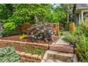 Landscaped front yard with stone retaining wall and lush plantings at 3321 W 29Th Ave, Denver, CO 80211