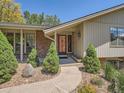 Inviting front entrance with a walkway, attractive landscaping, and a decorative front door at 4000 S Dahlia St, Cherry Hills Village, CO 80113