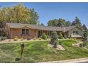 Charming home featuring a brick facade, manicured lawn, and inviting curb appeal at 4000 S Dahlia St, Cherry Hills Village, CO 80113