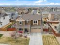 Expansive aerial view of a brown home nestled in a neighborhood with mountain views in the distance at 353 Zuniga St, Brighton, CO 80601