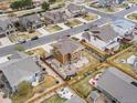 Drone shot displaying the home's fully fenced backyard, patio, and landscaping at 353 Zuniga St, Brighton, CO 80601