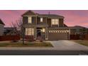 Charming home showcasing a covered porch, two-car garage, and stone accents at 353 Zuniga St, Brighton, CO 80601