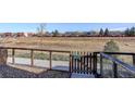 Enclosed backyard featuring metal fencing, gravel, and a gate, creating a private outdoor space at 10334 Milwaukee Cir, Thornton, CO 80229