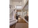 Elegant two-story home entryway with staircase, hardwood floors, neutral color palette, and decor at 216 N Monroe St, Denver, CO 80206