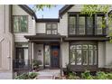 Inviting home featuring shuttered windows, gray siding, a front garden and covered entryway at 216 N Monroe St, Denver, CO 80206
