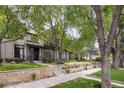 Charming home with a stone front garden, well manicured lawn and steps to the covered entryway at 216 N Monroe St, Denver, CO 80206